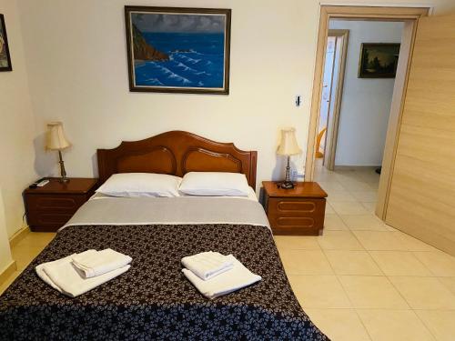 a bedroom with a bed with two towels on it at THE MANSION OF DIONISOS AND DIMITRAS in Linariá