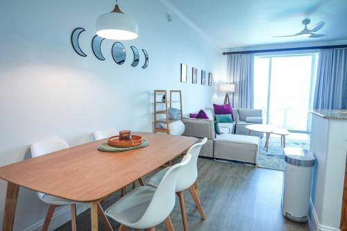 a kitchen and living room with a wooden table and chairs at Aparment 2nd floor 5 minutes from Disney in Orlando