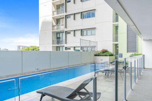 a balcony with a swimming pool in front of a building at Bowen Hills 1 Bedroom Apartment in Brisbane