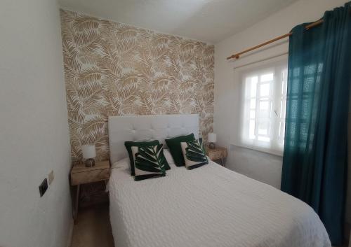 a bedroom with a bed with two pillows on it at Apartamento Faro de Sardina in Gáldar