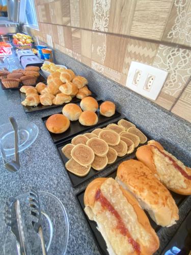 a bunch of breads and pastries on a counter at Pousada O Sol De Maragogi in Maragogi