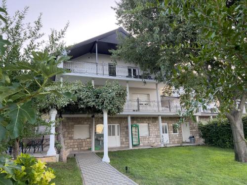 an apartment building with a balcony and a yard at Villa Ellie in Ljubuški