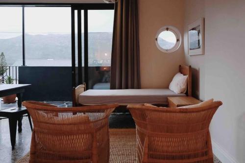 a hotel room with a bed and a table and chairs at The Sugarbush in Cape Town