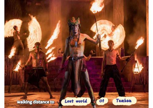 a group of men on a stage with flaming torches at JOMSTAY Sunway Onsen Suites Ipoh - Lost World of Tambun Ipoh Waterpark in Tambun