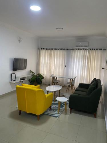 a living room with two couches and a table at Novara Apartments in Lekki