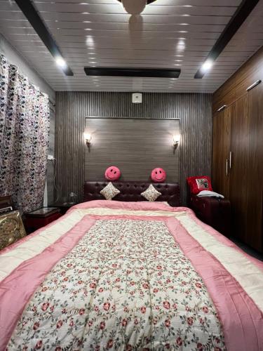 een slaapkamer met een groot bed met roze kussens bij Everest Guest House in Gulmarg