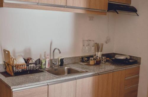 a kitchen with a sink and a counter top at AiPad Condo Rentals in Davao City