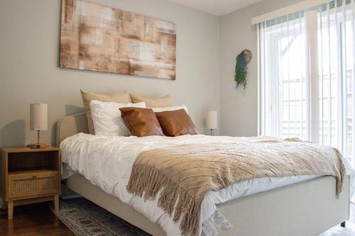 a bedroom with a large bed with brown pillows at Urban Oasis in University City in Philadelphia