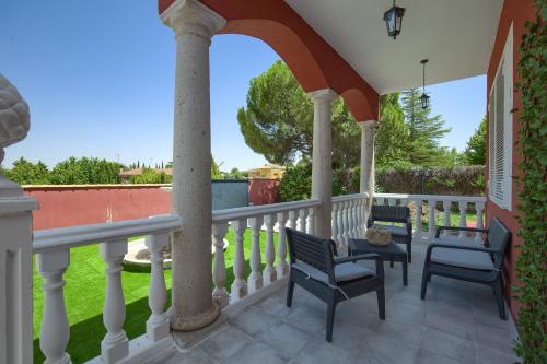 Un patio con sillas y una mesa en el balcón. en Lillo Rural, en Toledo