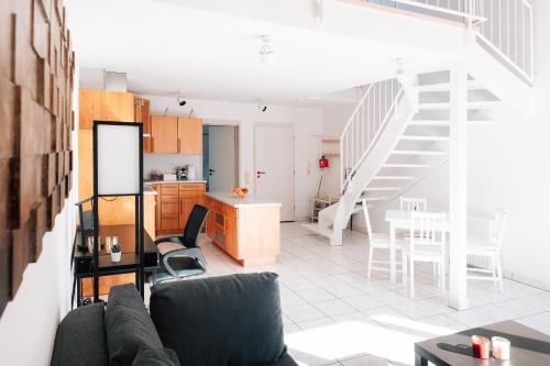 a living room and kitchen with a couch and a table at Maisonette-Wohnung Airport/Messe Stuttgart - Balkon - Parkplatz - Netflix in Filderstadt