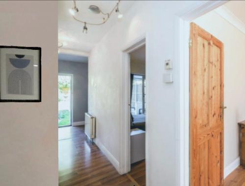 a hallway with a door leading to a living room at Walthamstow 1 bed in London