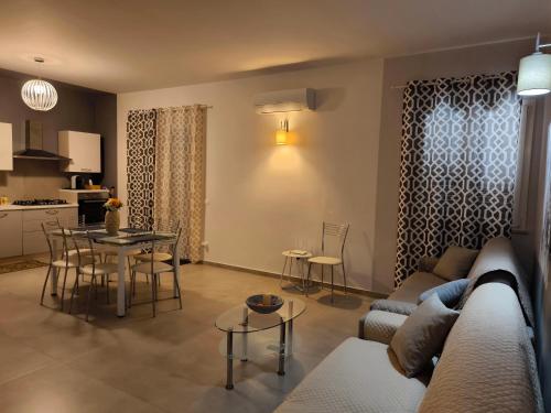 a living room with a couch and a table and a kitchen at CASADELMAR Relax VISTA MARE in San Leone