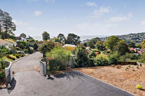 a driveway leading up to a house with a view at Conifers in Lyme Regis