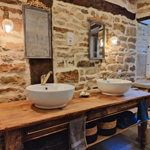 a bathroom with two sinks on a wooden table at Tourellerenard in Bussières-lès-Belmont