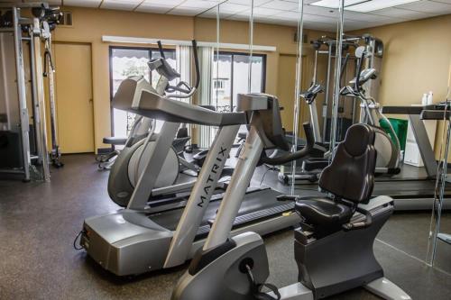 a gym with several cardio machines in a room at Quality Suites Downtown San Luis Obispo in San Luis Obispo