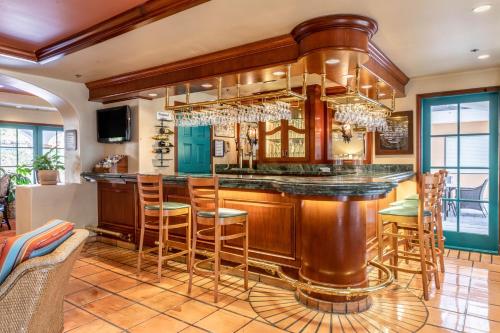 a kitchen with a large bar with stools at Quality Suites Downtown San Luis Obispo in San Luis Obispo