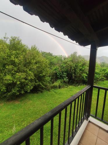 a rainbow from the balcony of a house at Allotino Hotel - Café & snacks in Stavrodhrómion