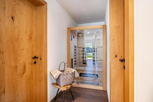 um quarto com um espelho e uma cadeira em frente a uma porta em Sunnseitn Lodge Exclusive Panorama em Stulles