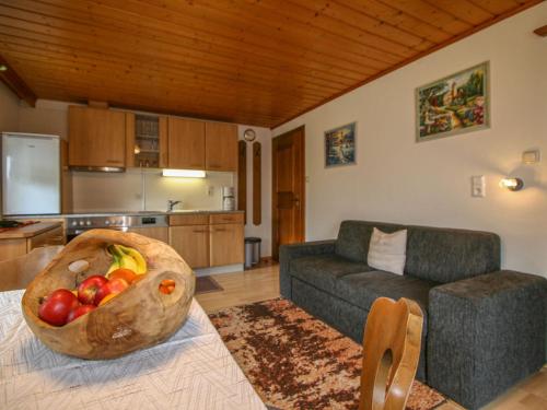 a living room with a bowl of fruit on a table at Appartement Neumann in Finkenberg