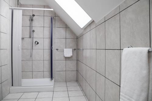 a bathroom with a shower and a walk in shower at Hotel Berlino in Milan