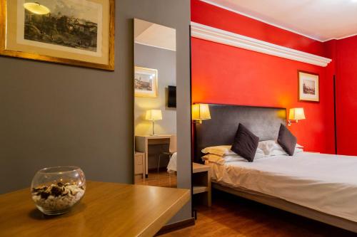 a room with a bed and a table with a bowl on it at Hotel Berlino in Milan