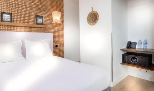 Кровать или кровати в номере Hôtel Emile Le Marais