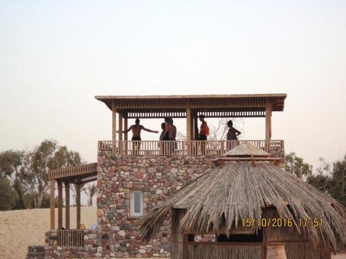 a group of people standing on top of a tower at Big Dune camp in Nuweiba