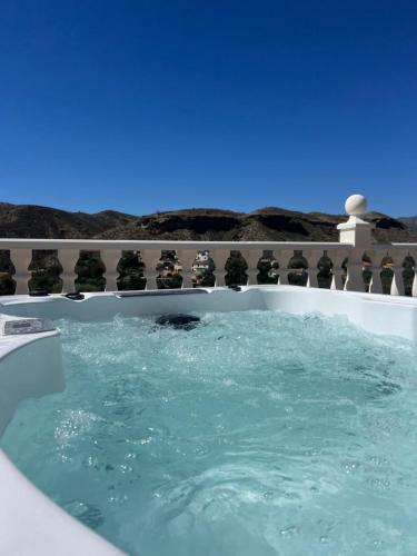 a jacuzzi tub with a view of the desert at Apartment with pool, hot tub and stunning views in Oria in Oria