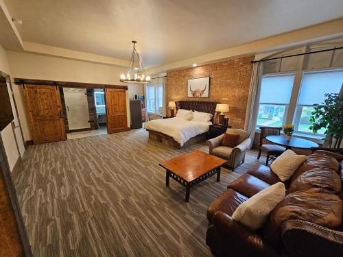 a large room with a bed and a couch at Eaglescape Suites and Event Center in Miles City