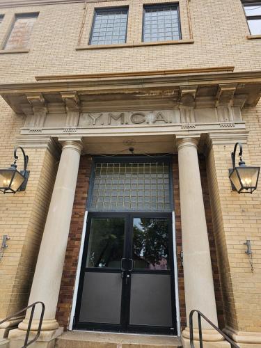 a entrance to a building with a large glass door at Eaglescape Suites and Event Center in Miles City