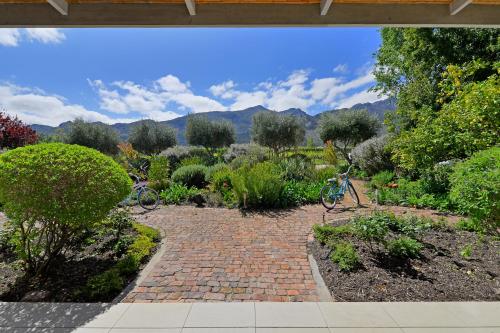 two bikes parked on a brick path in a garden at Fransvliet Guest House in Franschhoek