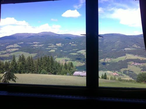 a view from a window of a field and mountains at Ferienwohnung - Apartement - Hotel Klippitz Nordost in Reichenfels