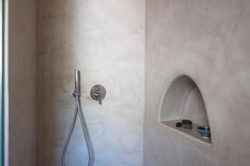 a shower in a bathroom with a shower head at Vico San Lorenzo - Camere a Salina in Malfa