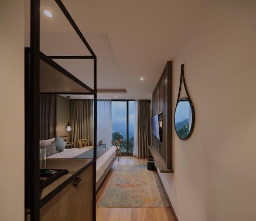a hotel room with a view of a bedroom at HIDE ELLA Hotel & Resort in Ella