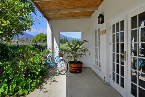 a house with a bike parked on a porch at Fransvliet Guest House in Franschhoek