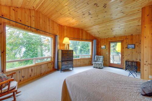 a bedroom with a bed and two windows at Tahuya Cabin Hood Canal and Olympic Mountain Views! in Tahuya