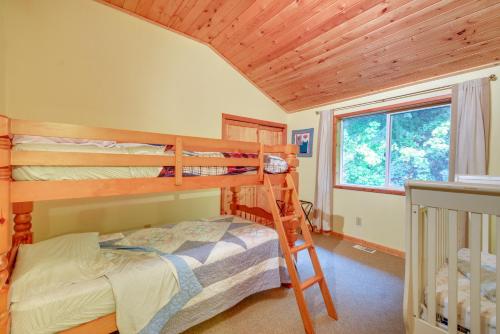 a bedroom with two bunk beds and a window at Tahuya Cabin Hood Canal and Olympic Mountain Views! in Tahuya