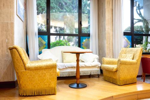 two chairs and a table in front of a window at Hotel San Nicola in Lagonegro