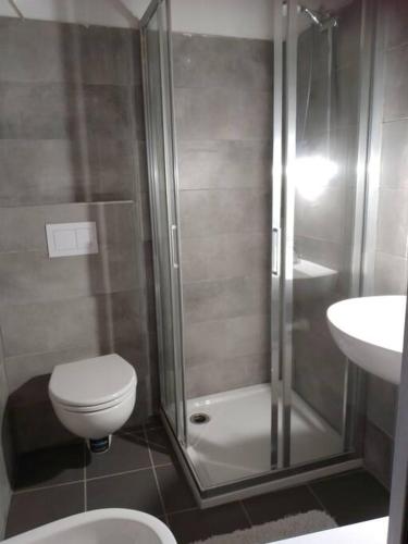 a bathroom with a shower and a toilet and a sink at casettina Vittoria in Consiglio di Rumo