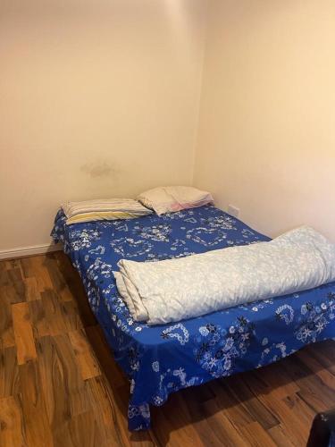 a small bedroom with a bed with a blue blanket at Shropshire in Parkside