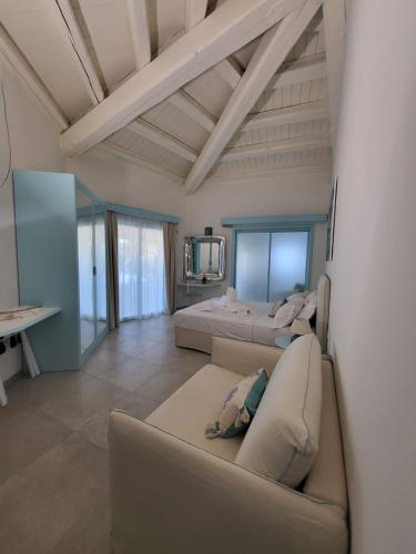 a living room with two beds and a couch at Oasi Blu Sardinia in Santa Margherita di Pula