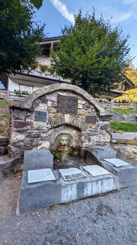 a stone wall with a monument in front of it at Gästehaus Fehrenbacher Schweiz in Masserberg
