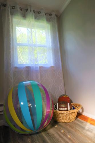 a room with a window and a large ball and a basket at Farm Country House with Pool and Huge Property in Blakeslee