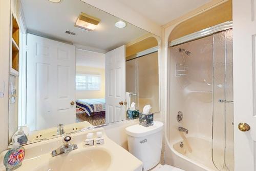 a bathroom with a sink and a shower and a toilet at Midlake Memories in Lake Harmony