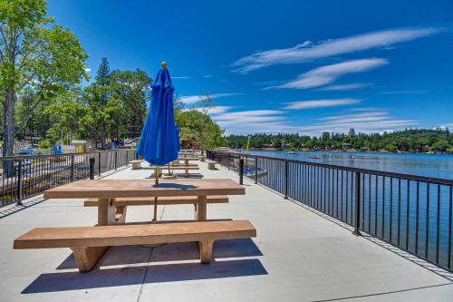 a blue umbrella sitting on a picnic table next to the water at Big Creek Hideaway in Groveland