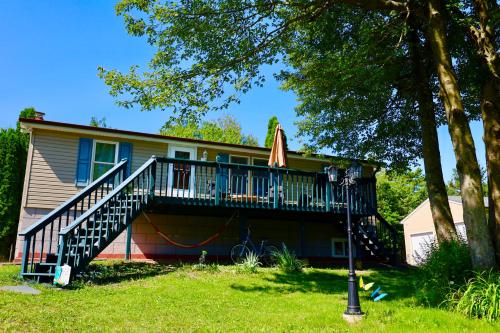 a house with a porch with a deck at Farm Country House with Pool and Huge Property in Blakeslee