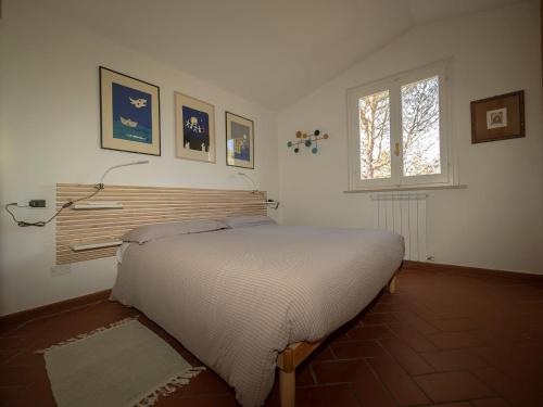 a bedroom with a bed in a room with a window at Villa Utilia into the wild in Perugia