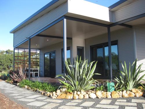 a house with a screened in porch with plants at Hartzell One Seven in Metricup