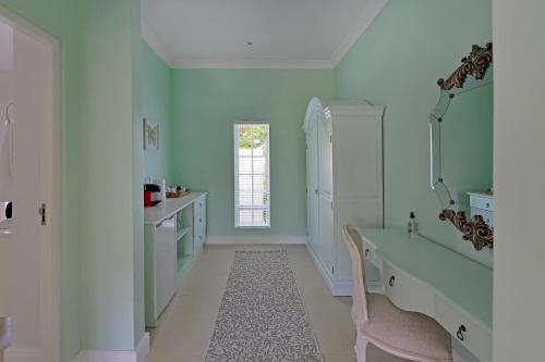 a bathroom with a bath tub and a sink at Fransvliet Guest House in Franschhoek