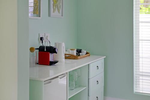 a kitchen with a counter top with a white counter top at Fransvliet Guest House in Franschhoek